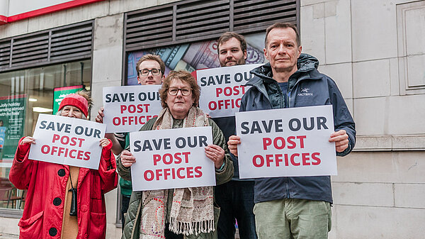 Lib Dem activists, holding "save our post offices" signs