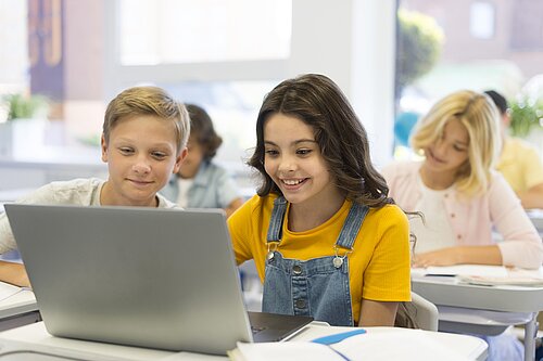Children using a laptop in school