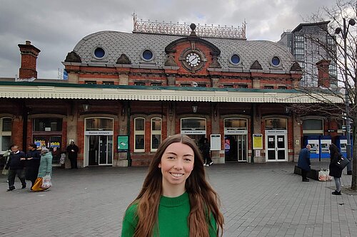 Chelsea Whyte, Parliamentary Candidate for Slough in front of Slough Station