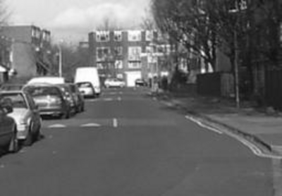 A typical residential road, with wide carriageways and clear sightlines encouraging motorists to drive fast.