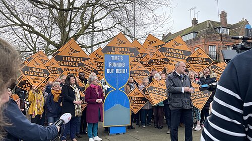 Ed Davey and Daisy Cooper in front of yellow diamonds