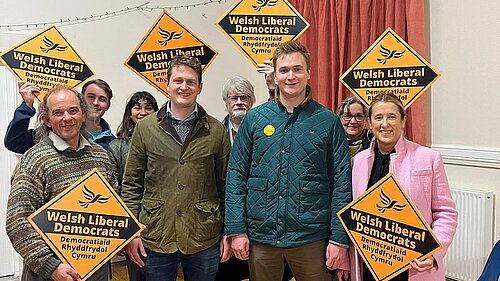 Newley elected Cllr Raiff Devlin celebrating with Jane Dodds MS, David Chadwick and others