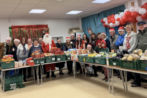 Photo of Liberal Democrat councillors and volunteers at Feed the Community Foodbank on Convamore Road, helping sort donations and support local families.
