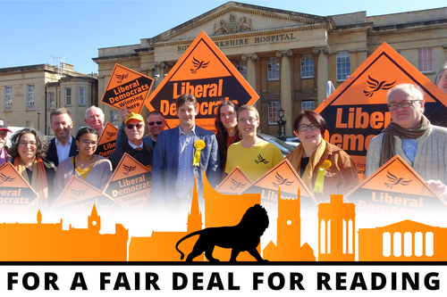 The Reading Lib Dem candidates cheering with placards outside the Royal Berkshire Hospital