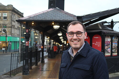 Tom stood in front of Harrogate bus station