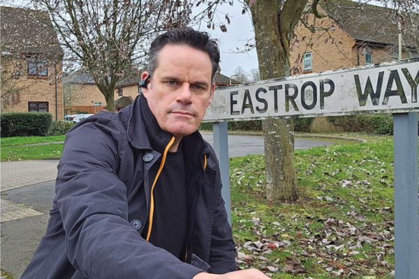 Gavin James in front of road sign at Eastrop Way