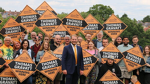 Thomas Gravatt with a crowd of Lib Dems with signs 