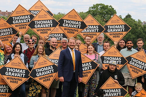 Thomas Gravatt with a crowd of Lib Dems with signs 
