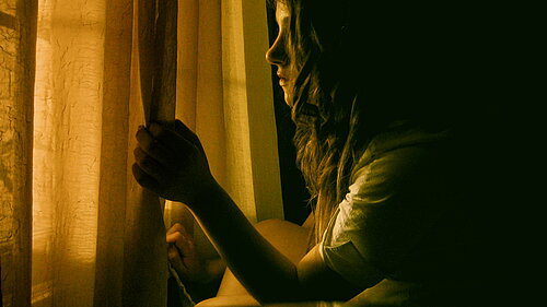 Girl looking out of window