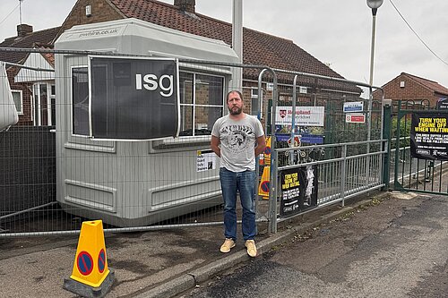 Nigel Ayre standing by Hempland primary school