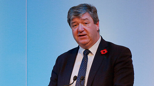 Alistair Carmichael speaks at a podium
