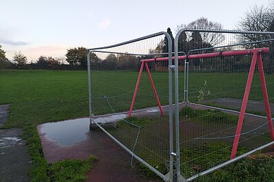 The park would be better served with something like a bench that can be used, rather than a cordoned swing set