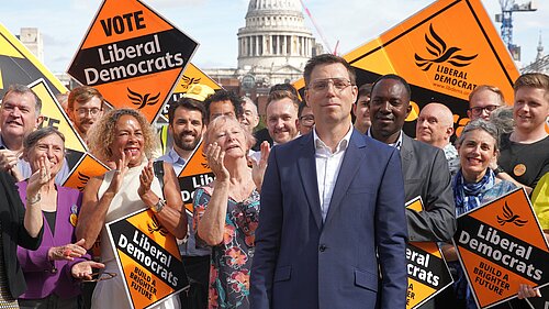 Rob Blackie pictured with Liberal Democrat activists holding signs