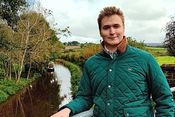 Raiff standing in front of the Brecon Canal