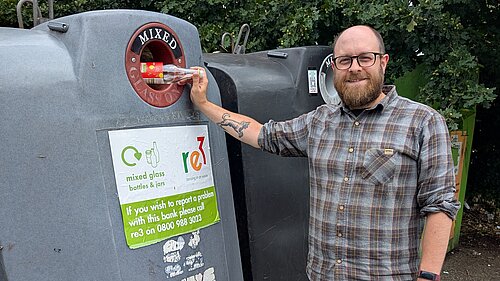 Councillor James Moore with glass recycling.