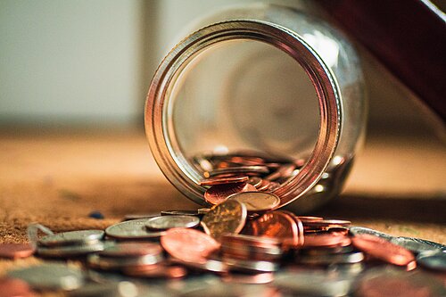 Coins coming out of a jar