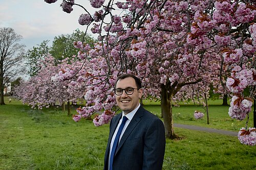 Tom Gordon stood on the Stray in front of the blossom trees